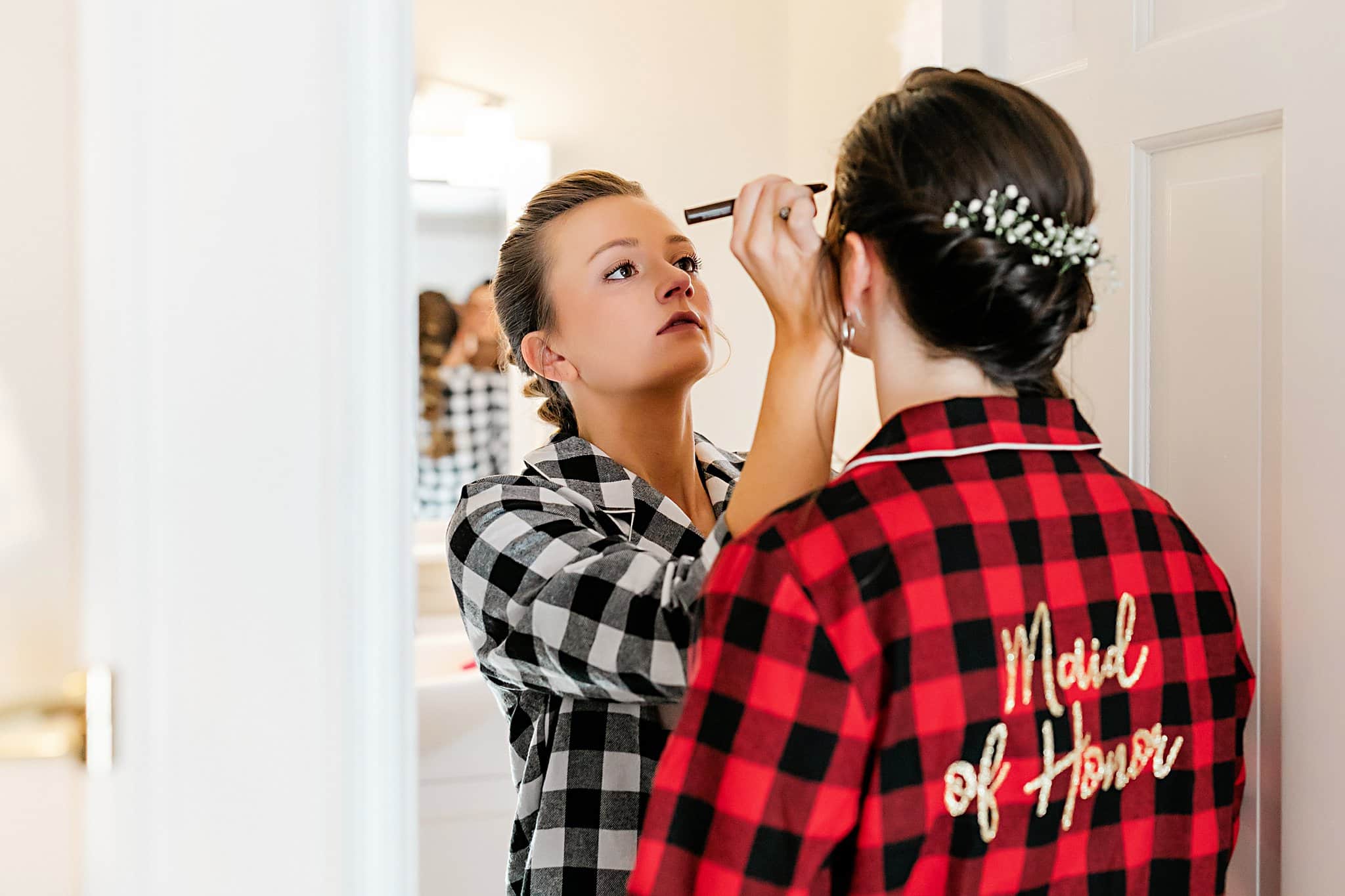 Festive Christmas Wedding Ideas Bride Putting Makeup on Maid of Honor