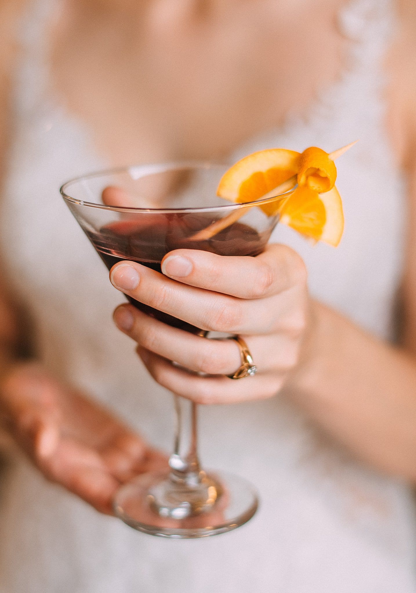 Bride Holding Cocktail Juice Spritzer Recipe With Citrus Garnish