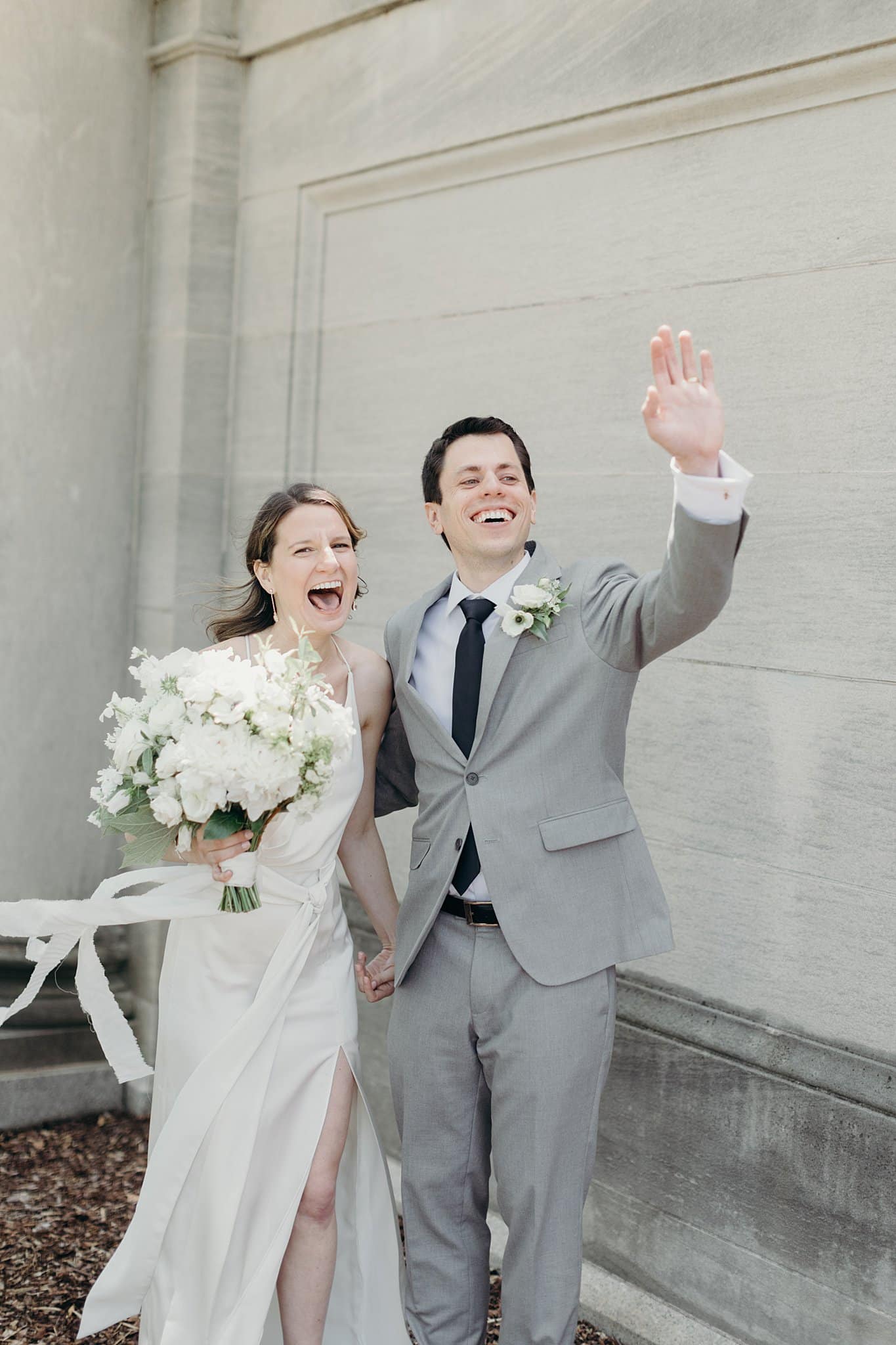 Couple Waving After Wedding Ceremony