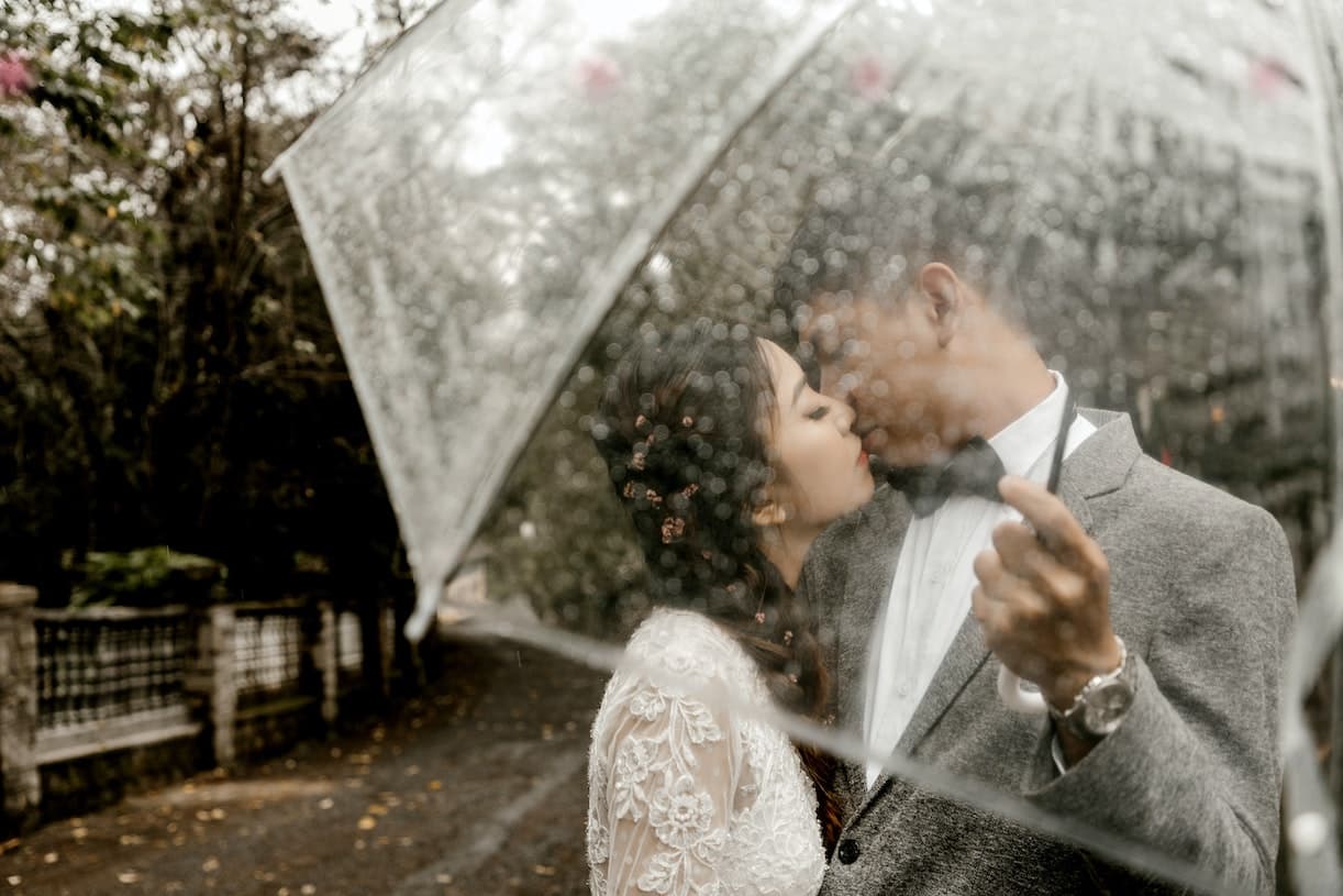 Couple with Rain Umbrella on their Big Day