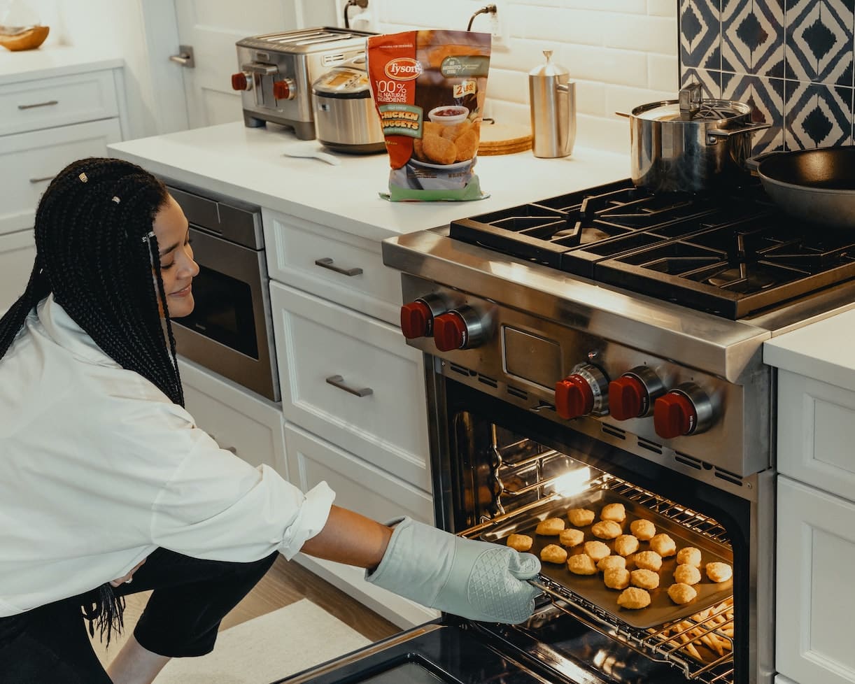 Woman Pulling Food Out of Oven